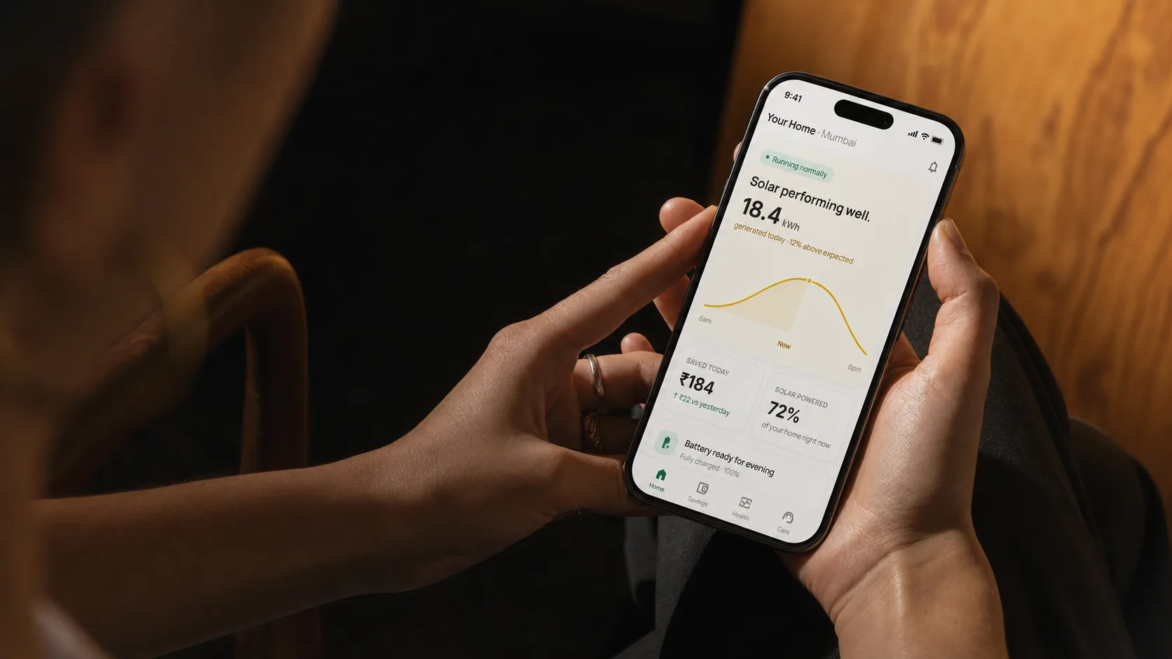 Arka mobile app shown on a phone held in warm ambient light